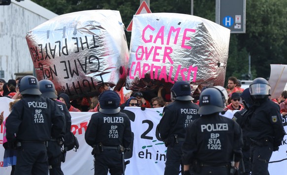 epa06071935 Protesters attend the demonstration at the Hamburg Harbour during the G20 summit in Hamburg, Germany, 07 July 2017. They hold a banner with the inscription &#039;Game Over Capitalsim&#039; ...