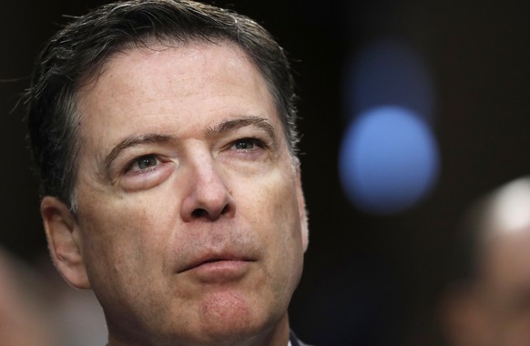 Former FBI Director James Comey pauses as he speaks during a Senate Intelligence Committee hearing on Capitol Hill, Thursday, June 8, 2017, in Washington. (AP Photo/Alex Brandon)