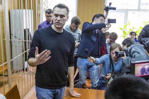 Russian opposition leader Alexei Navalny speaks to press in a court room in Moscow, Russia, Monday, March 27, 2017. Russian opposition leader Alexei Navalny is making a court appearance Monday, a day  ...