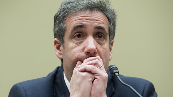 epa07402694 Michael Cohen, former attorney to US President Donald J. Trump, reacts while listening to the closing remarks of House Oversight and Reform Committee Chairman Elijah Cummings, while appear ...