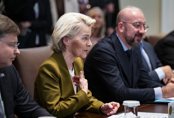 epa10929396 European Commission President Ursula von der Leyen (C) speaks next to European Council President Charles Michel (R) during a meeting in the Cabinet Room of the White House in Washington, D ...