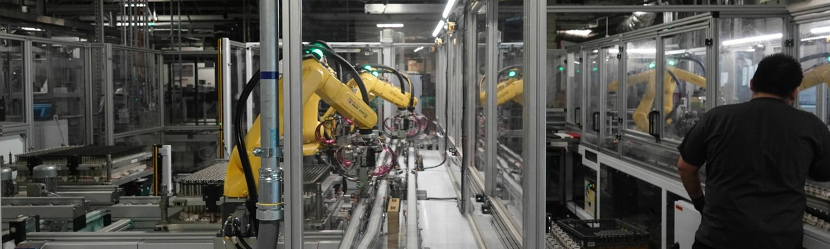 FILE - In this Dec. 3, 2018 photo, robots at the Tesla Gigafactory help assemble battery cells from Panasonic into battery packs for Tesla's Model 3 sedan and other products in Reno, Nev. Tesla s ...