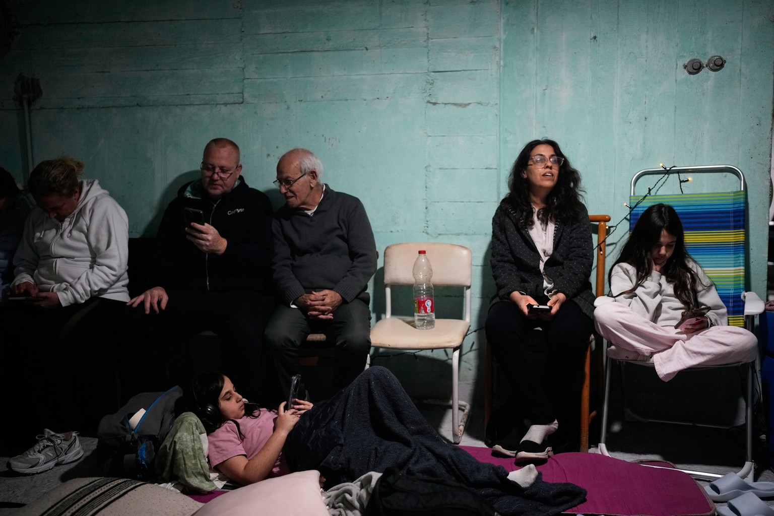 People take shelter as air raid sirens warning of incoming Iranian missiles in Tel Aviv, Israel, Friday, March 6, 2026. (AP Photo/Ohad Zwigenberg)
Israel Iran Mideast Wars