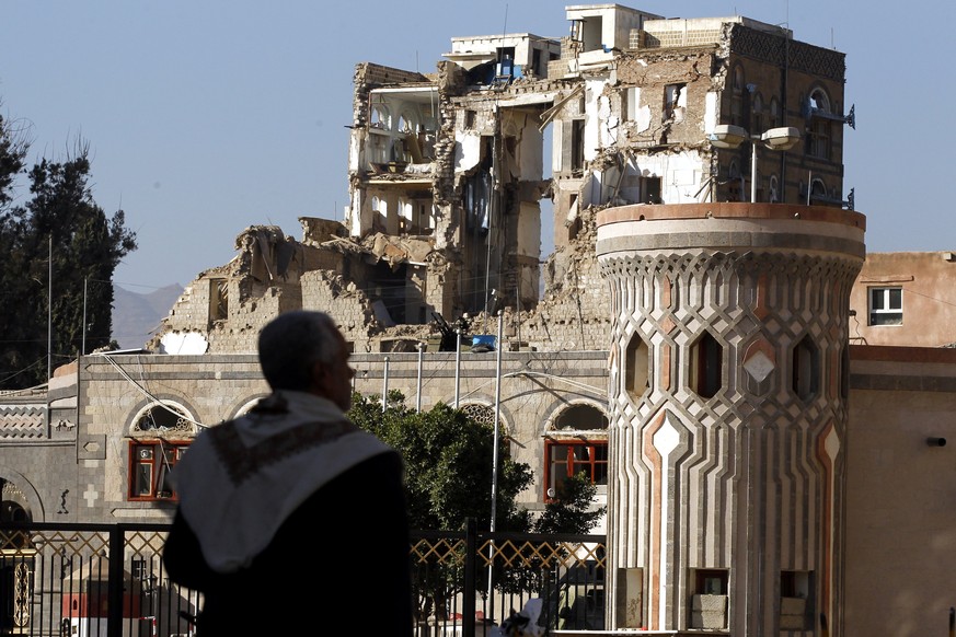 epa06368115 A Yemeni walks past the republican palace allegedly destroyed by several Saudi-led airstrikes after Houthi militants killed Yemens ex-president Ali Abdullah Saleh, in Sanaa, Yemen, 05 De ...