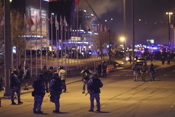 Russian Rosguardia (National Guard) servicemen secure an area near the Crocus City Hall on the western edge of Moscow, Russia, Friday, March 22, 2024. Several gunmen have burst into a big concert hall ...