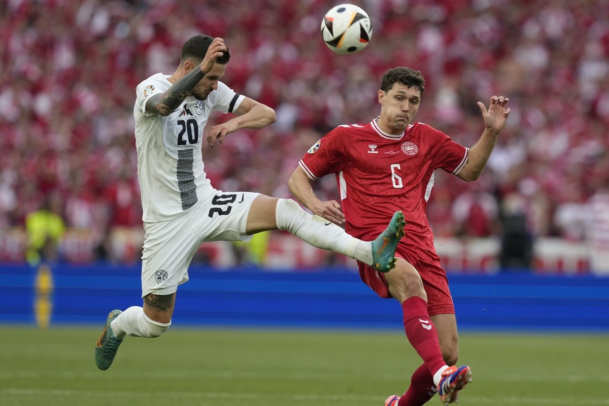 Slovenia's Petar Stojanovic, left, and Denmark's Andreas Christensen fight for the ball during a Group C match between Slovenia and Denmark at the Euro 2024 soccer tournament in Stuttgart, G ...