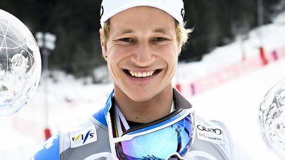 Marco Odermatt of Switzerland poses with the men&#039;s overall crystal globe trophy and the men&#039;s Giant-Slalom overall leader crystal globe trophy after the podium ceremony at the FIS Alpine Ski ...