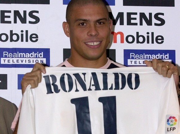Brazilian soccer star Ronaldo holds up his new Real Madrid shirt during his presentation to the press in Madrid, Spain Monday Sept. 2, 2002. Ronaldo, who previously played for Italian club Inter Milan ...