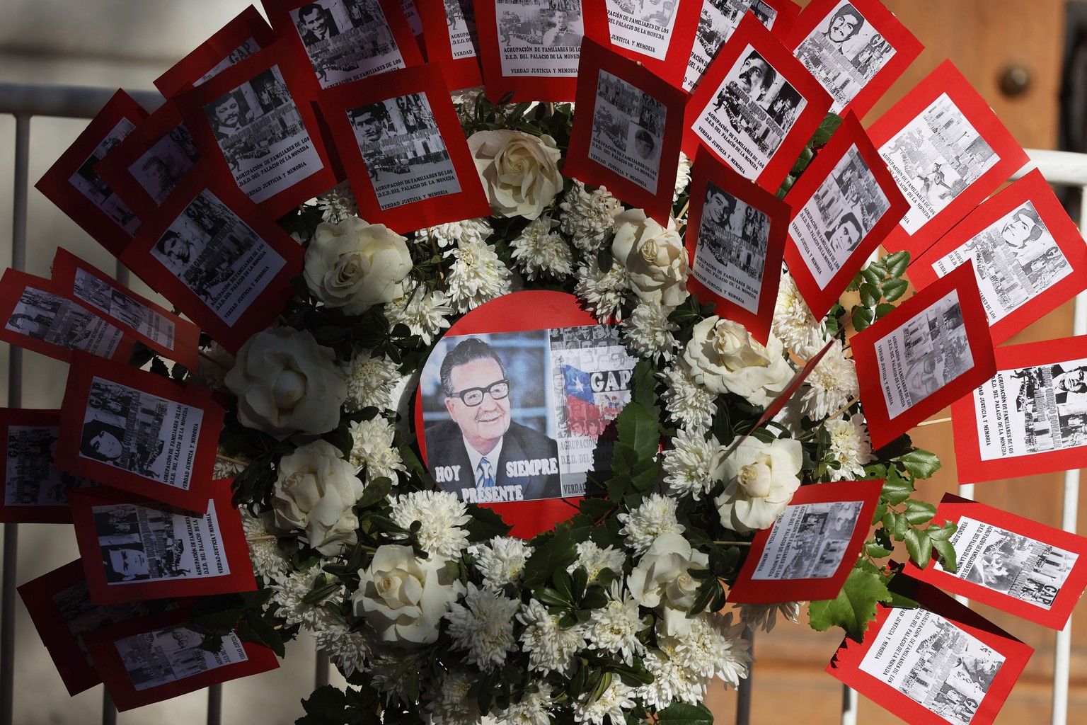 epa12369860 A view of a floral arrangement with the image of former Chilean president Salvador Allende during the commemoration of the 52nd anniversary of the coup d'�tat in front of La Moneda Pa ...