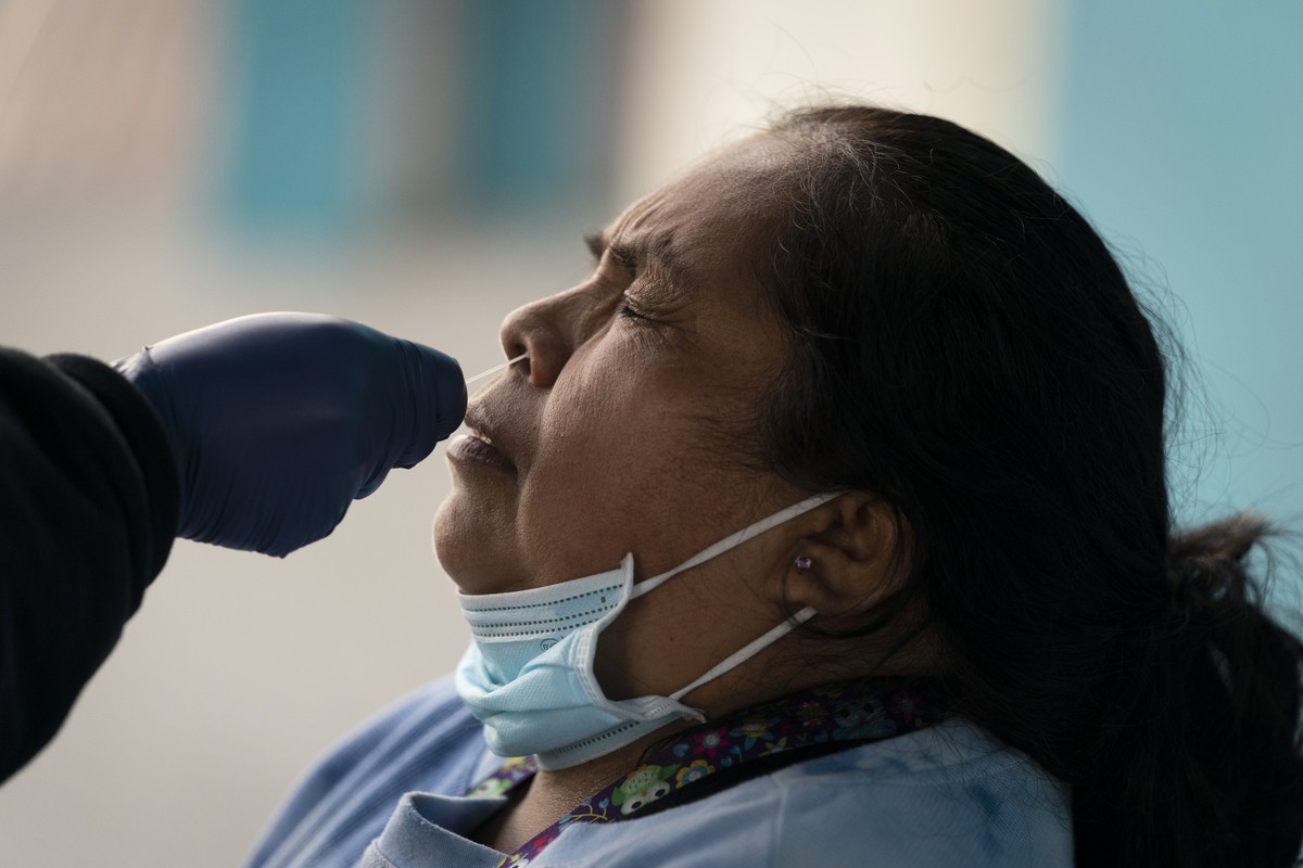 Leticia Lopez gets her sample collected for a COVID-19 test at a pop-up testing and vaccination site outside a swap meet in Los Angeles, Wednesday, Dec. 15, 2021. The new omicron coronavirus mutant sp ...