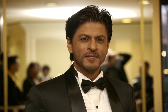 Shah Rukh Khan poses for photographers as they arrive at The Asian Awards in central London, Friday, April 17, 2015. (Photo by Joel Ryan/Invision/AP)