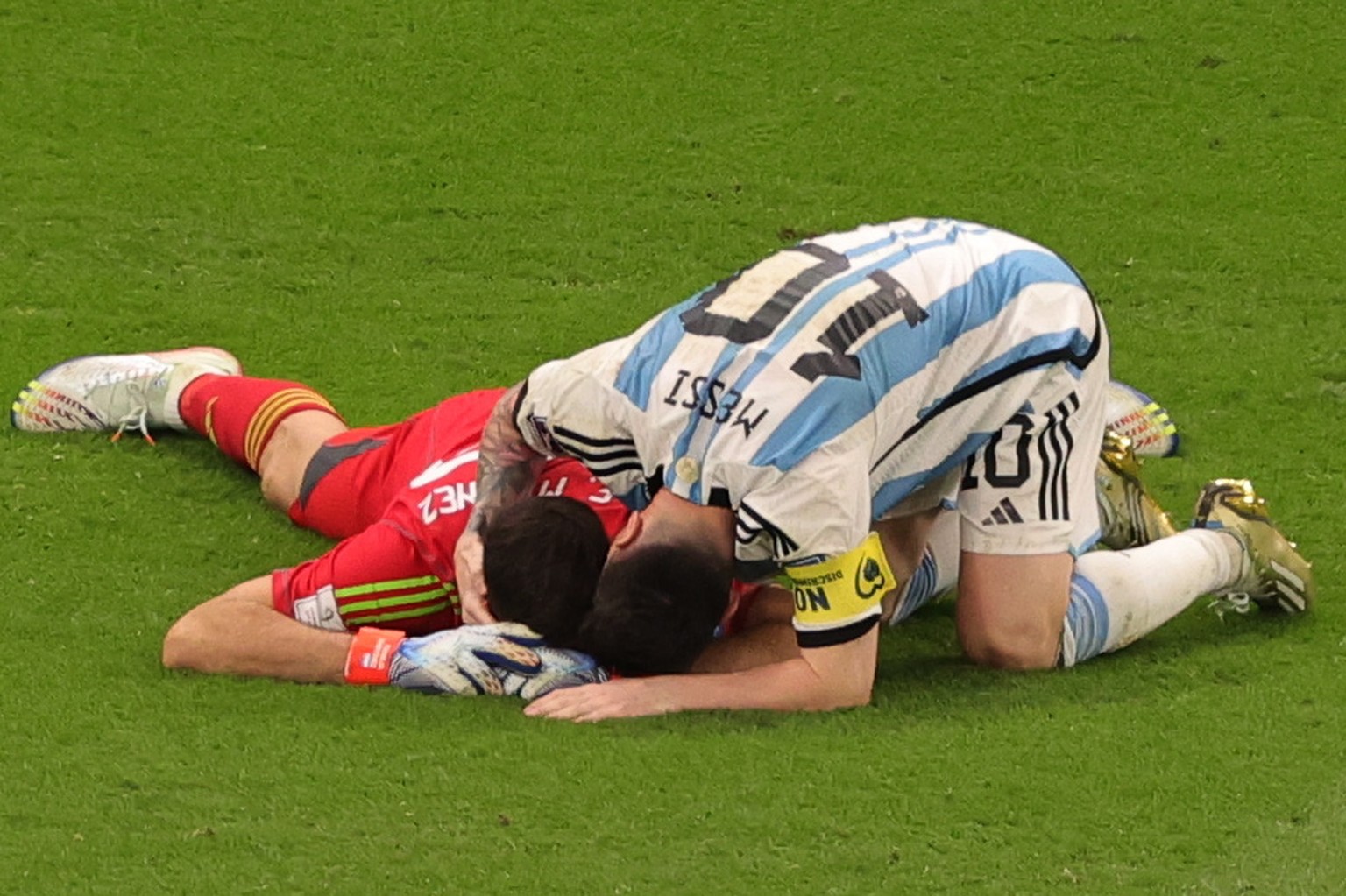 epa10358293 Lionel Messi of Argentina congratulates his teammate goalkeeper Emiliano Martinez after the FIFA World Cup 2022 quarter final soccer match between the Netherlands and Argentina at Lusail S ...