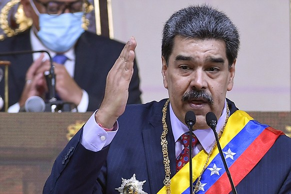 Venezuelan President Nicolas Maduro delivers his annual address to the nation before lawmakers at the National Assembly in Caracas, Venezuela, Saturday, Jan. 15, 2022. (AP Photo/Matias Delacroix)