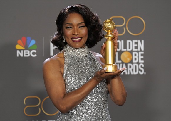 Angela Bassett poses in the press room holding the award for Best Performance by a Supporting Actress in a Motion Picture for "Black Panther: Wakanda Forever" at the 80th Annual Go...