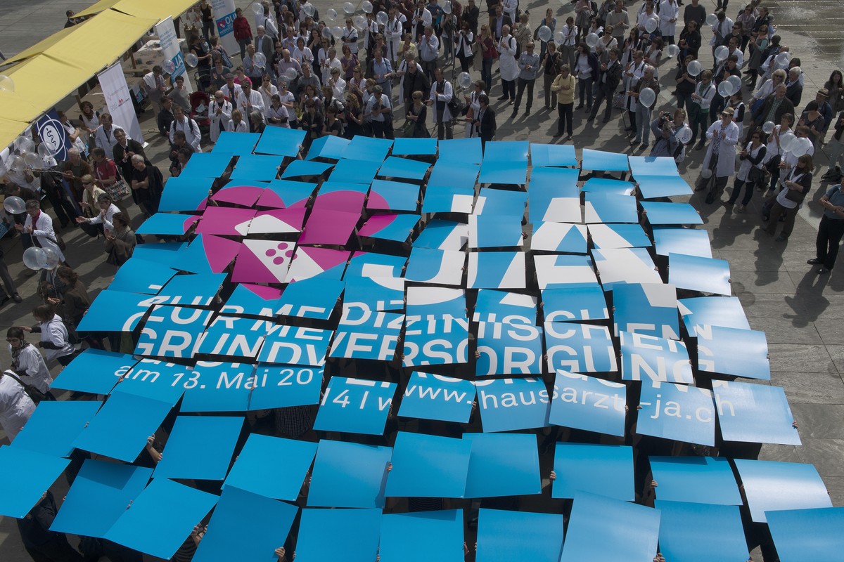 Hausaerztinnen und Hausaerzte werben mit einer Plakataktion fuer die Hausarztmedizin am Dienstag, 1. April 2014 auf dem Bundesplatz in Bern. Die Volksabstimmung ueber den "Bundesbeschluss ueber d ...
