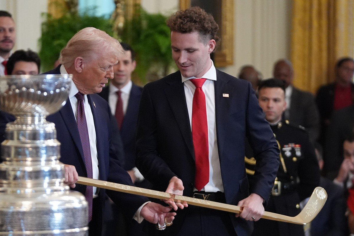President Donald Trump holds a hockey stick presented to him by Matthew Tkachuk during an event to honor the 2025 Stanley Cup Champion Florida Panthers in the East Room of the White House, Thursday, J ...