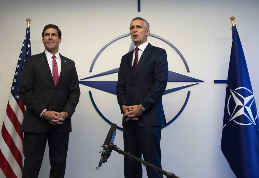 U.S. Secretary for Defense Mark Esper, left, and NATO Secretary General Jens Stoltenberg make a statement to the media prior to a meeting of NATO defense ministers at NATO headquarters in Brussels, Th ...