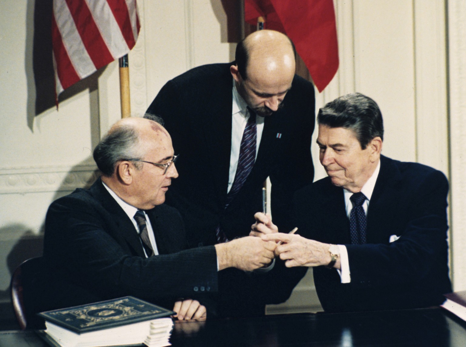 FILE - In this Dec. 8, 1987 file photo U.S. President Ronald Reagan, right, and Soviet leader Mikhail Gorbachev exchange pens during the Intermediate Range Nuclear Forces Treaty signing ceremony in th ...