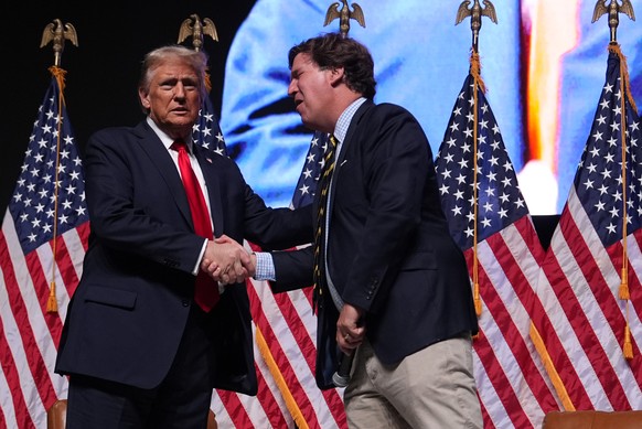 Republican presidential nominee former President Donald Trump speaks with Tucker Carlson during a Tucker Carlson Live Tour show at Desert Diamond Arena, Thursday, Oct. 31, 2024, in Glendale, Ariz. (AP ...
