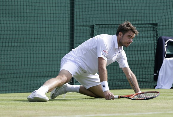 Stan Wawrinka of Switzerland looks up after falling to the ground as plays Richard Gasquet of France during the men&#039;s quarterfinal singles match at the All England Lawn Tennis Championships in Wi ...