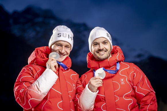 Silver medalist Switzerland's Marco Odermatt, left, and silver medalist Switzerland's Loic Meillard, right, pose for a photo after the men's alpine skiing team combined slalom race at t ...