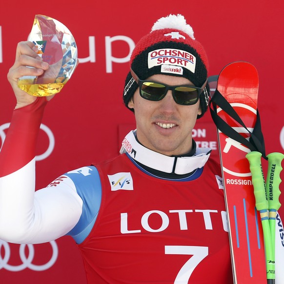 Winner Carlo Janka of Switzerland holds his trophy during the award ceremony for a men&#039;s World Cup super-G race, also a test event for the Pyeongchang 2018 Winter Olympics, at the Jeongseon Alpin ...