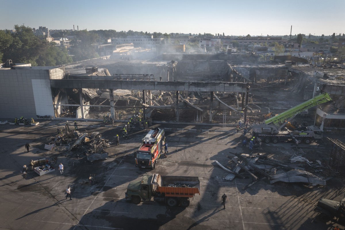 Ukrainian State Emergency Service firefighters work to take away debris at a shopping center burned after a rocket attack in Kremenchuk, Ukraine, Tuesday, June 28, 2022. Residents of the quiet, rivers ...