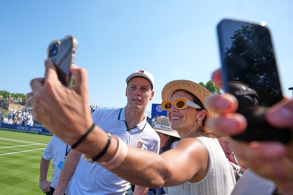 Jannik Sinner of Italy poses for pictures after a tennis exhibition match against Cameron Norrie of Great Britain at the Hurlingham Tennis Club in London, Wednesday, June 24, 2026.(AP Photo/Kirsty Wig ...