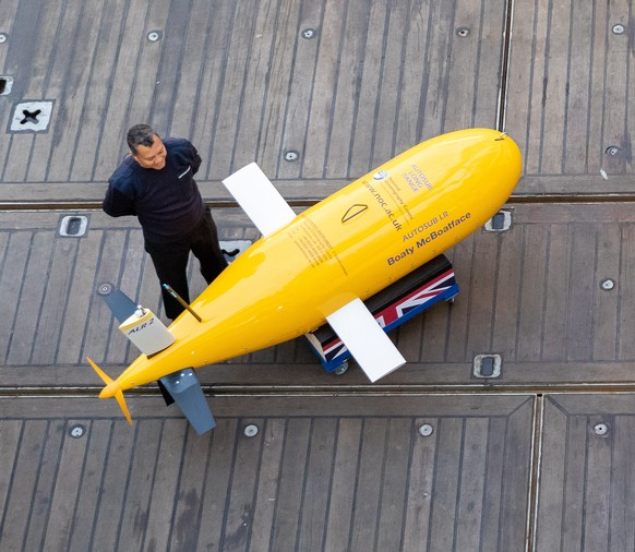 epa09550688 Visitors take photographs of the ?Boaty McBoatface? robotic sub onboard the RSS Sir David Attenborough new polar research ship in Greenwich, London, Britain, 28 October 2021. Britain?s new ...