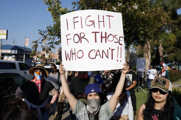 epa12170872 People gather for a rally following an incident where ICE agents rammed into a car to take a man into custody in the Boyle Heights neighborhood earlier that day; in Los Angeles, California ...