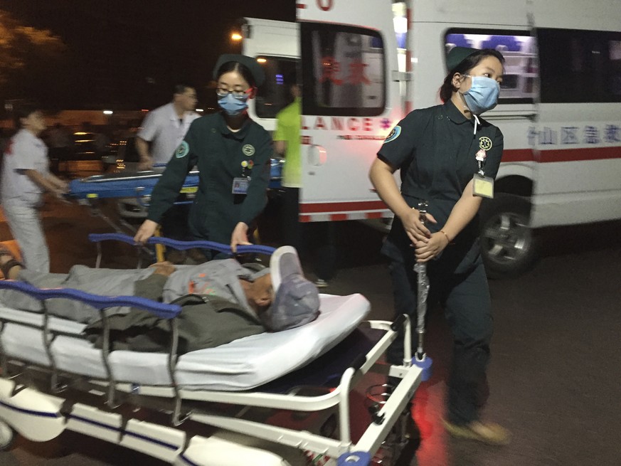 In this photo released by China&#039;s Xinhua News Agency, medical workers transport a person injured in an explosion outside a kindergarten into a hospital in Fengxian County in eastern China&#039;s  ...