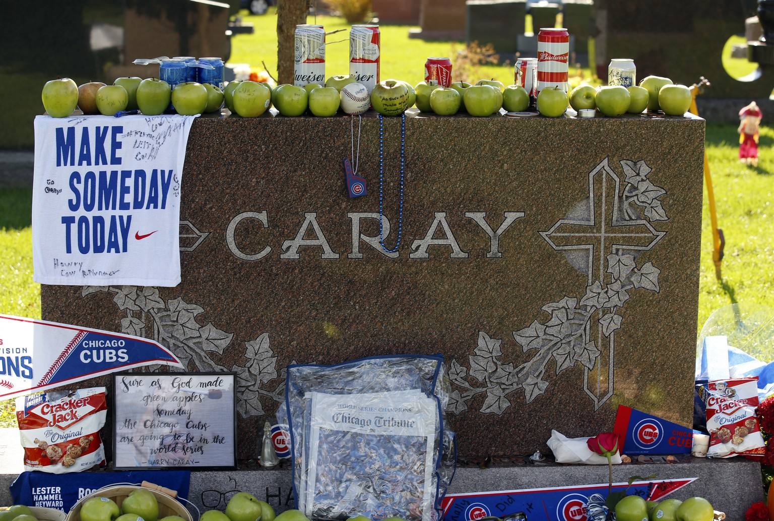 Numerous items are displayed at the grave of the late Chicago Cubs broadcaster Harry Caray, Thursday Nov. 3, 2016 at All Saints Cemetery in Des Plaines, Il,. A surprising amount of fans made the trip  ...