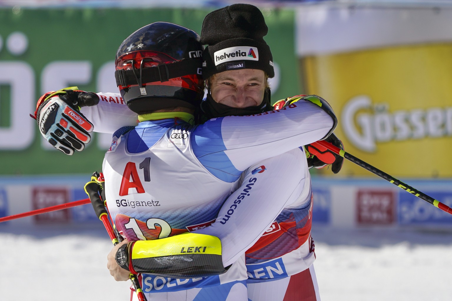 Switzerland&#039;s Gino Caviezel, left, and his teammate Marco Odermatt hug each other in the finish area after completing alpine ski, men&#039;s World Cup giant slalom in Soelden, Austria, Sunday, Oc ...