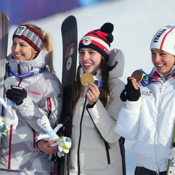 From left, silver medalist Austria's Sabine Payer, gold medalist Czechia's Zuzana Maderova and bronze medalist Italy's Lucia Dalmasso celebrate after the women's snowboarding paral ...