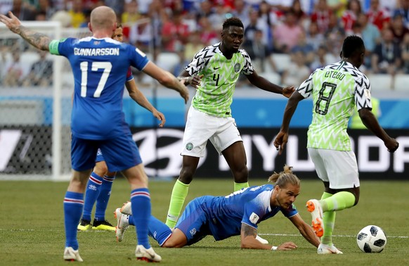 epa06831141 Rurik Gislason (down) of Iceland reacts during the FIFA World Cup 2018 group D preliminary round soccer match between Nigeria and Iceland in Volgograd, Russia, 22 June 2018.

(RESTRICTIO ...