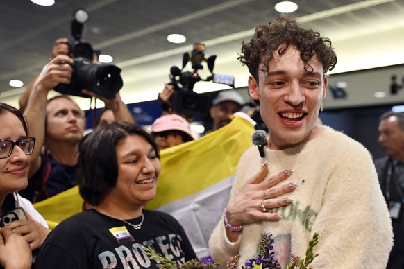 epa11336252 Swiss singer Nemo (R), the winner of the 68th edition of the Eurovision Song Contest (ESC), arrives at Zurich Airport in Kloten, Switzerland, 12 May 2024. Nemo represented Switzerland with ...