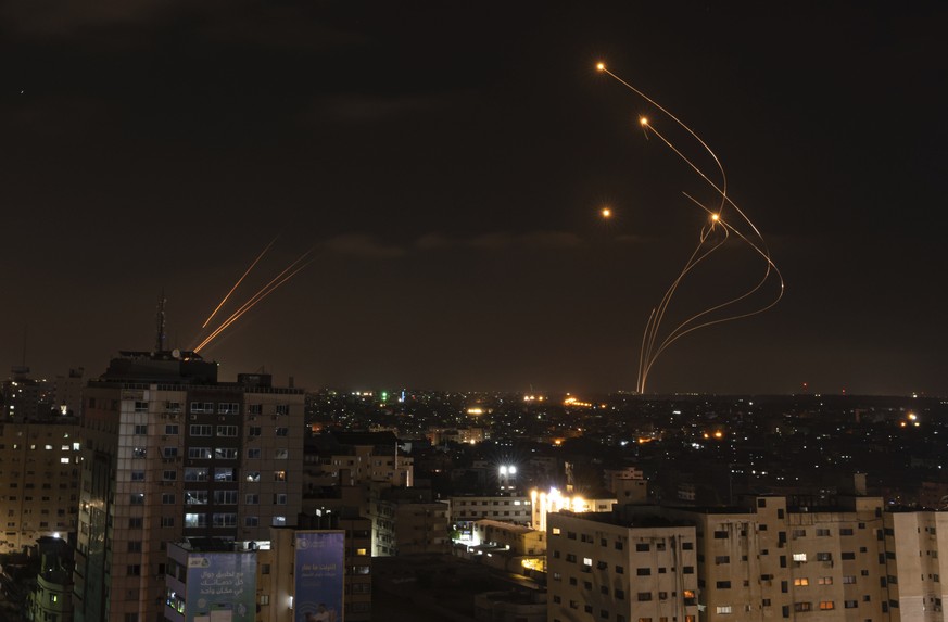 Rockets fired from Gaza and intercepted by Israel&#039;s Iron Dome anti-missile system over Israeli skies are seen from Gaza City, Saturday, May 13, 2023. (AP Photo/Fatima Shbair)