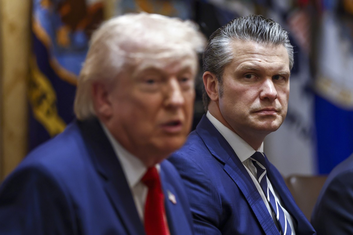 epa12851612 US Secretary of Defense Pete Hegseth (R) listens as President Donald J. Trump delivers remarks during a cabinet meeting in the Cabinet Room of the White House in Washington, DC, USA, 26 Ma ...