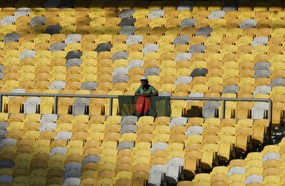 A supporter stands behind a Bangladesh flag during a qualifier against Bahrain for the 2023 AFC Asian Cup to be held at National Stadium Bukit Jalil in Kuala Lumpur, Malaysia, on Wednesday, June 8.