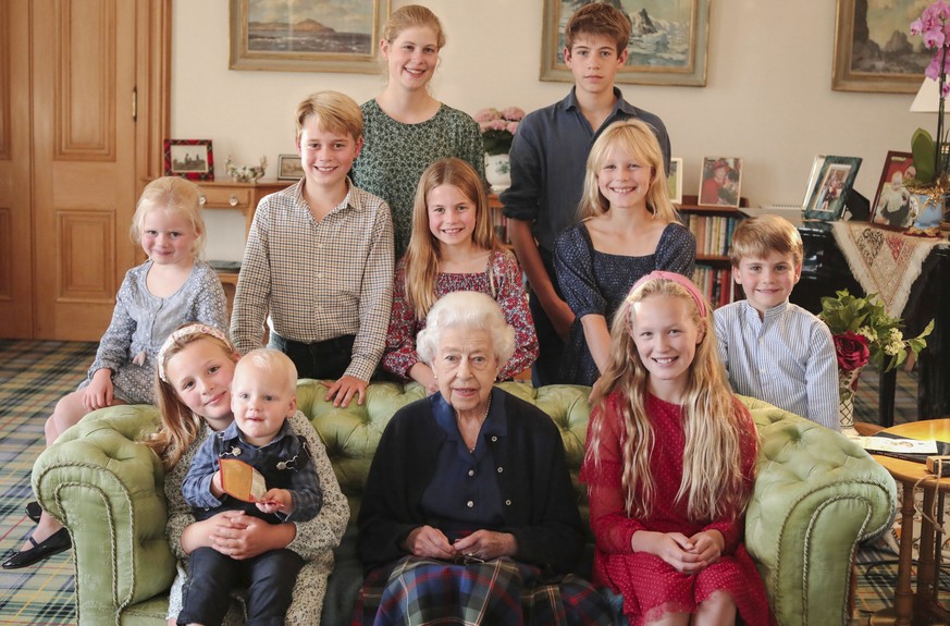 In this undated photo provided by Kensington Palace, Britain&#039;s Queen Elizabeth II poses for a photo in Balmoral, Scotland, with some of her grandchildren and great grandchildren. Back from from l ...