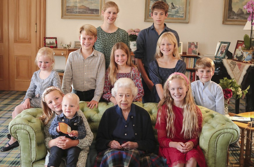 In this undated photo provided by Kensington Palace, Britain's Queen Elizabeth II poses for a photo in Balmoral, Scotland, with some of her grandchildren and great-grandchildren.  Back from l...