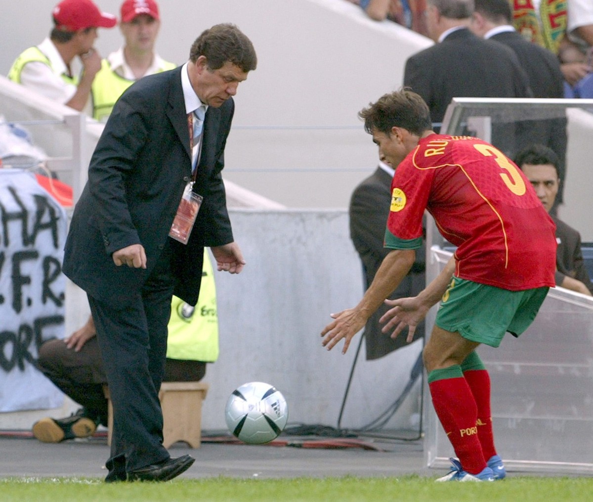 Otto Rehhagel (L), the German coach of the Greek national team, gives the ball to Portuguese player Rui Jorge during the Group A match of the EURO 2004 at Estadio do Dragao in Porto, Saturday 12 June  ...