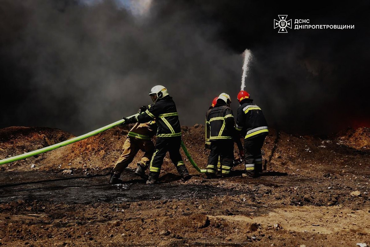 In this photo provided by the Ukrainian Emergency Service, emergency services personnel work to extinguish a fire following a Russian drone attack on a gas pipeline in Dnipropetrovsk region, Ukraine,  ...