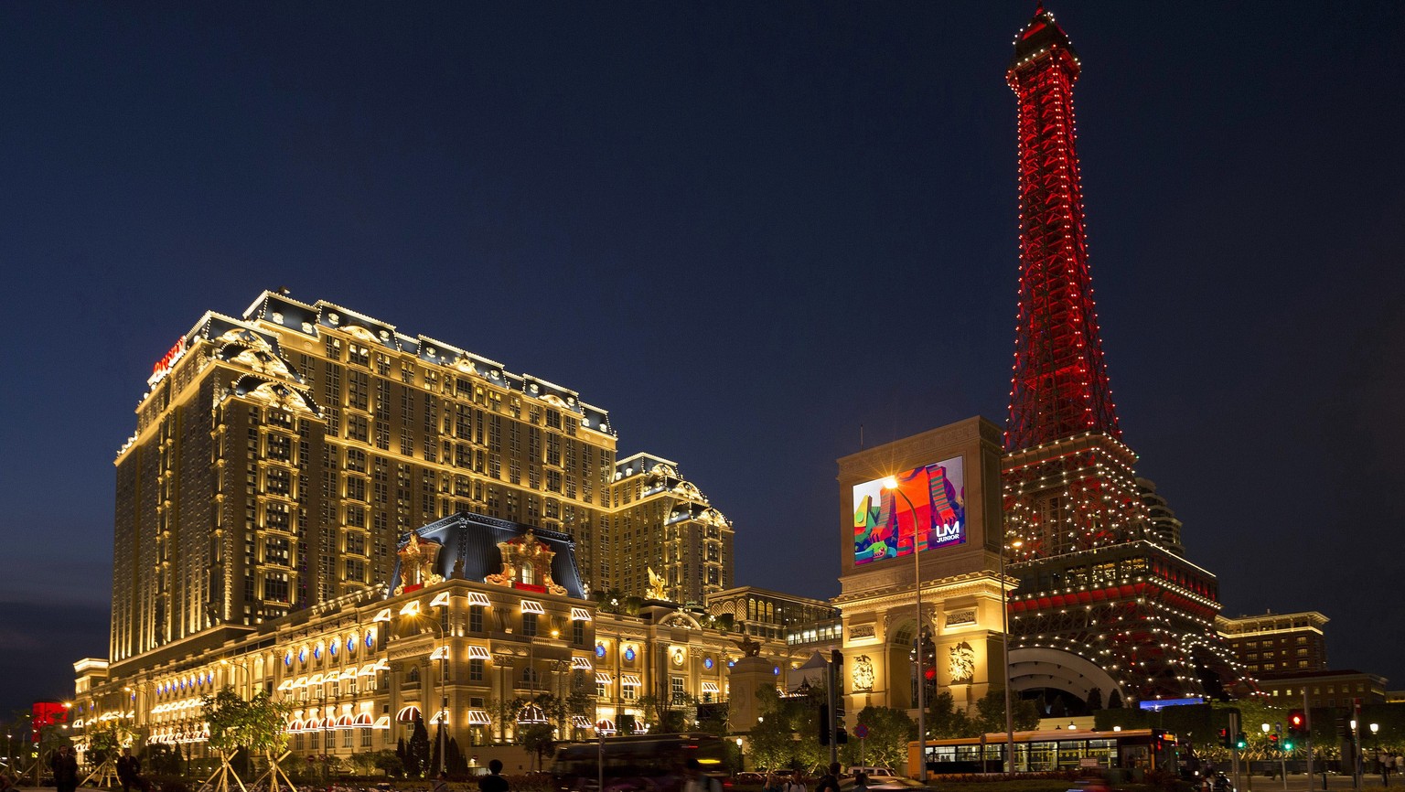 epa05537848 The new luxury hotel resort 'Parisian', owned by American casino magnate Sheldon Adelson, illuminated as it opens in Macao, China, 13 September 2016. The new hotel resort inspired by Paris ...