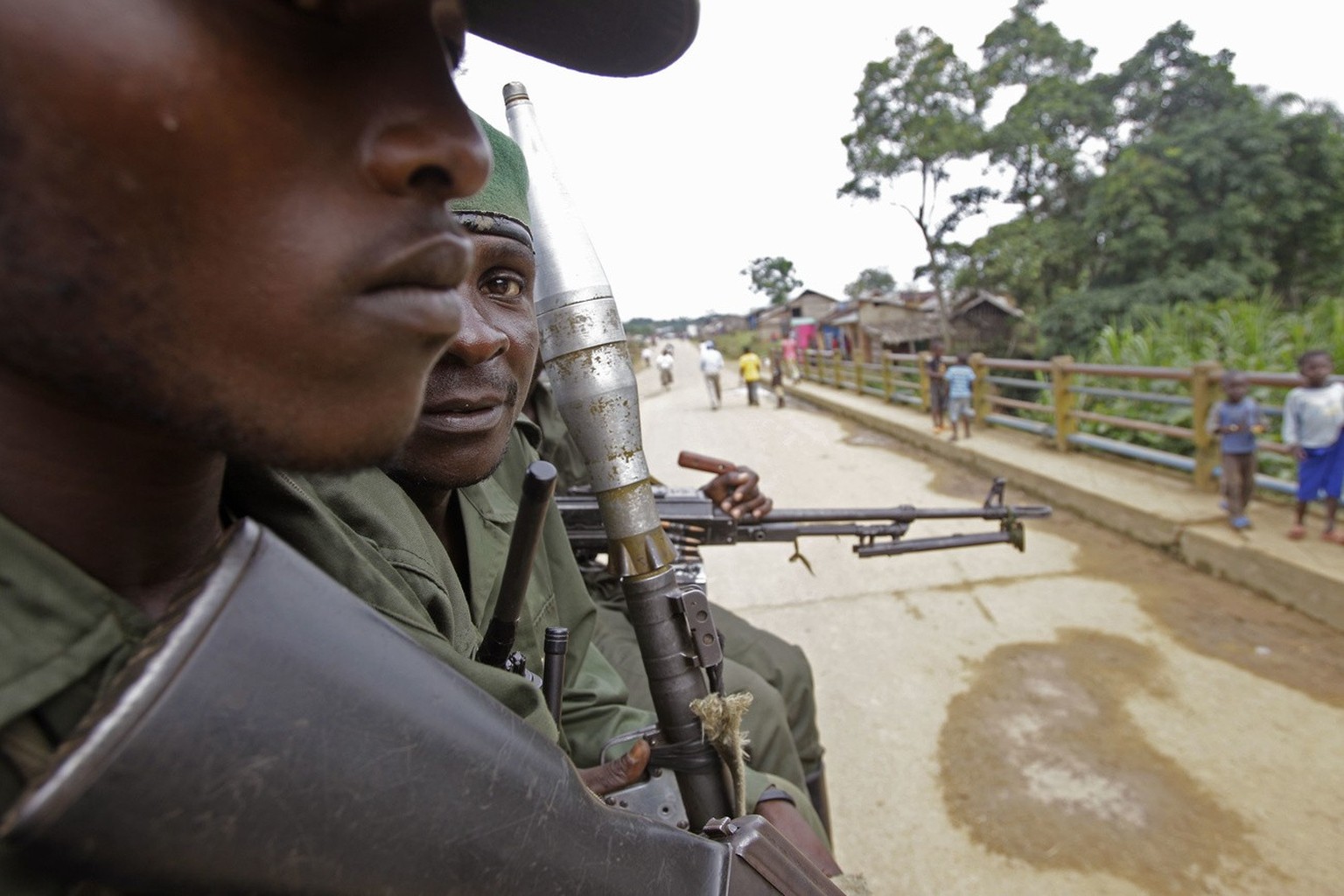 Congolese soldier&#039;s sit on the back of a truck as it drives through the small town off Walikale, Congo, Tuesday, Sept. 21, 2010. Violence is reaching new levels of savagery and spiraling out of c ...