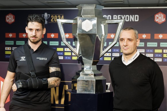 Geneve-Servette&#039;s captain Noah Rod, left, and Geneve-Servette&#039;s Head coach Jan Cadieux, pose next to the CHL trophy after a press conference one day before the Champions Hockey League Final  ...