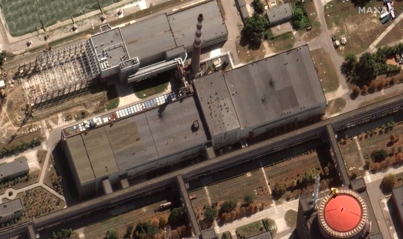 This satellite image provided by Maxar Technologies shows recent damage to the roof of a building adjacent to several of the nuclear reactors at the Zaporizhzhia nuclear plant in Russian occupied Ukra ...
