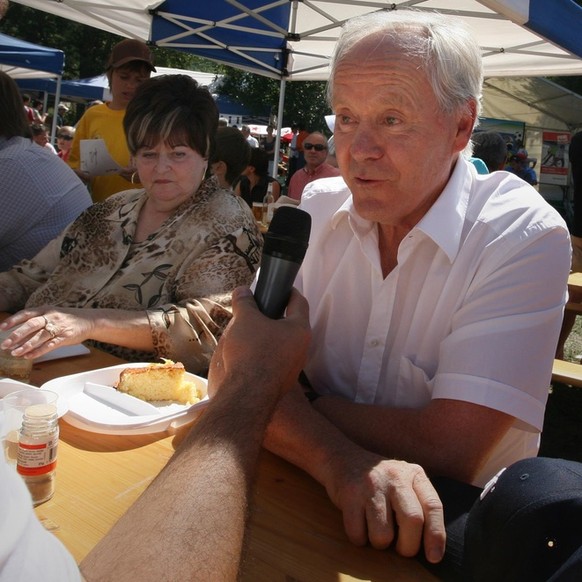 Koebi Kuhn, right, former coach of the Swiss national soccer team, is interviewed, sitting next to his wife Alice, middle, during the twelfth edition of the Sepp Blatter Tournament, in Ulrichen, Switz ...