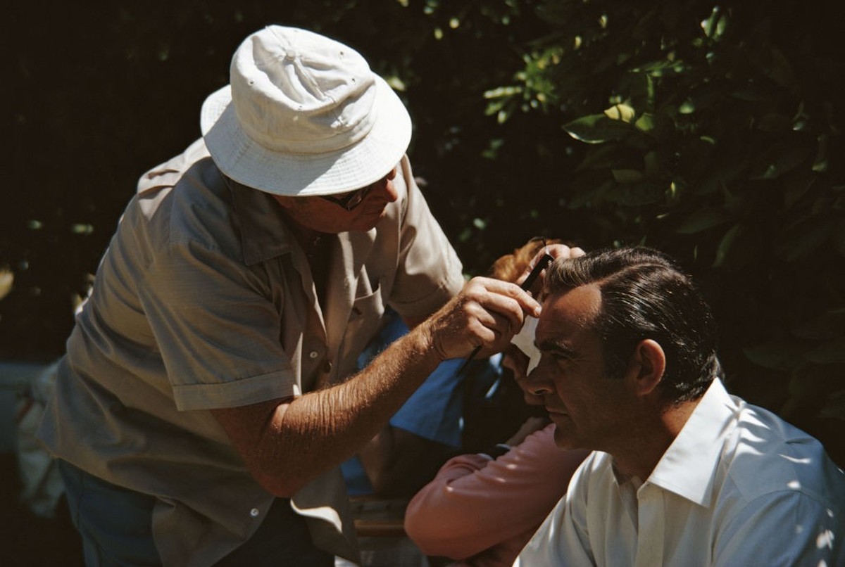 A member of the crew combs Scottish actor Sean Connery's hair on the set of the James Bond film 'Diamonds Are Forever', USA, May 1971. (Photo by Anwar Hussein/Getty Images)