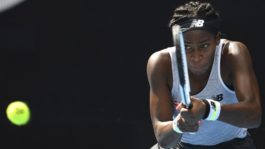 Coco Gauff of the U.S. makes a backhand return to compatriot Sofia Kenin during their fourth round singles match at the Australian Open tennis championship in Melbourne, Australia, Sunday, Jan. 26, 20 ...